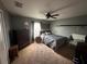 Cozy bedroom featuring neutral colors, a ceiling fan, dresser, and ample closet space at 13416 Algoma Ave, Spring Hill, FL 34609