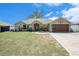 Inviting single-story home showcasing a manicured lawn and stylish two-car garage, perfect for comfortable living at 13416 Algoma Ave, Spring Hill, FL 34609