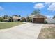 Charming one-story home with long driveway, modern garage door, and well-manicured lawn at 13416 Algoma Ave, Spring Hill, FL 34609