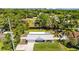 Aerial view showcases property with lush trees and a serene waterscape enhancing its appeal at 1414 Sunset Ln, Lutz, FL 33549