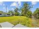 Serene backyard overlooking canal waters with a dock ready for leisure and water activities at 1414 Sunset Ln, Lutz, FL 33549
