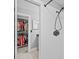 Bright bathroom with a white tiled shower and dark fixtures plus a closet at 1414 Sunset Ln, Lutz, FL 33549