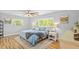 Bright bedroom featuring a comfortable bed, ceiling fan, and natural light from the windows at 1414 Sunset Ln, Lutz, FL 33549