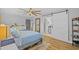 Serene bedroom with ensuite bathroom access through sliding barn door at 1414 Sunset Ln, Lutz, FL 33549