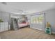 This bedroom features bunk beds, a window, and neutral colored carpet at 1414 Sunset Ln, Lutz, FL 33549