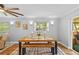 Cozy dining area with rustic wooden table, bench seating, and a stylish ceiling fan at 1414 Sunset Ln, Lutz, FL 33549