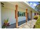 Inviting front porch featuring natural wood columns and stone accents, offering curb appeal at 1414 Sunset Ln, Lutz, FL 33549