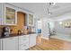 Stylish kitchen featuring white cabinets, a decorative backsplash, and modern track lighting at 1414 Sunset Ln, Lutz, FL 33549