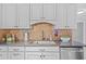 Modern kitchen sink with stainless steel appliances, dark countertops and tile backsplash at 1414 Sunset Ln, Lutz, FL 33549