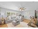 Bright living room with a comfortable gray sectional sofa, wood flooring, and stylish decor at 1414 Sunset Ln, Lutz, FL 33549