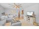 Bright and airy living room featuring a gray sectional sofa, wood floors, and modern decor at 1414 Sunset Ln, Lutz, FL 33549