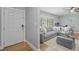 Comfortable living room with a plush gray sectional sofa, neutral tones, and ample natural light at 1414 Sunset Ln, Lutz, FL 33549