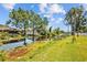 Scenic pond view showcasing lush greenery, a dock, and serene waterfront scenery at 1414 Sunset Ln, Lutz, FL 33549