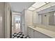 Bathroom features a checkerboard floor, a long vanity, and a view of the living room at 1460 Gulf Blvd # 1206, Clearwater Beach, FL 33767