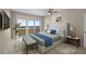 This bright main bedroom boasts balcony access, a plush king bed, and calming coastal views at 1460 Gulf Blvd # 1206, Clearwater Beach, FL 33767