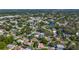 An aerial view of a residential neighborhood with mature trees and a blue stream at 1469 S Hillcrest Ave, Clearwater, FL 33756