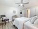 Bright bedroom with white walls, wood floors, and minimalist decor featuring a modern ceiling fan at 1469 S Hillcrest Ave, Clearwater, FL 33756