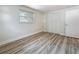 Bedroom with wood flooring, one window with blinds and closet doors at 1469 S Hillcrest Ave, Clearwater, FL 33756