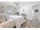 Airy bedroom featuring light-colored walls, wood floors, white linens, and natural light at 1469 S Hillcrest Ave, Clearwater, FL 33756