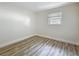 Clean bedroom with wood-look flooring, freshly painted walls and bright natural light at 1469 S Hillcrest Ave, Clearwater, FL 33756