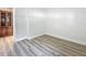 Bedroom with wood flooring and view into den with shelving at 1469 S Hillcrest Ave, Clearwater, FL 33756
