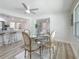 Bright dining room with a modern ceiling fan and glass top dining table at 1469 S Hillcrest Ave, Clearwater, FL 33756