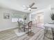 Bright dining room with modern ceiling fan and a glass top dining table at 1469 S Hillcrest Ave, Clearwater, FL 33756