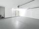 Well-lit, empty garage space with painted floors, a functional overhead door, and access to the interior at 1469 S Hillcrest Ave, Clearwater, FL 33756