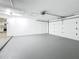 A spacious and bright two-car garage with clean, painted floors at 1469 S Hillcrest Ave, Clearwater, FL 33756