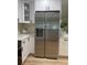 Updated kitchen with stainless steel refrigerator and white cabinets and modern countertops at 1469 S Hillcrest Ave, Clearwater, FL 33756