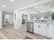 Bright kitchen boasts modern appliances and pristine white cabinetry, seamlessly flowing into the adjacent dining area at 1469 S Hillcrest Ave, Clearwater, FL 33756