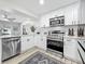 Updated kitchen featuring white cabinets, stainless steel appliances, and wood flooring at 1469 S Hillcrest Ave, Clearwater, FL 33756