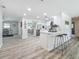 Open-concept kitchen with white cabinets, modern appliances, and seamless flow to dining area at 1469 S Hillcrest Ave, Clearwater, FL 33756