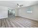 Bright living room with wood flooring, ceiling fan, exterior door and view to dining area at 1469 S Hillcrest Ave, Clearwater, FL 33756