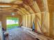 Shed interior with exposed wood framing and a view to the backyard, perfect for storage at 1469 S Hillcrest Ave, Clearwater, FL 33756