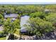 Overhead view of a flat-roofed home with colorful shutters, lush greenery, mature landscaping, and well-maintained grounds at 1535 Nursery Rd # 111, Clearwater, FL 33756