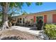 Backyard patio features outdoor seating and mature shade trees with lush plantings at 1535 Nursery Rd # 111, Clearwater, FL 33756