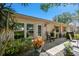 Back patio with outdoor seating, lush plantings and view of home's exterior at 1535 Nursery Rd # 111, Clearwater, FL 33756