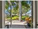 Backyard patio and grassy area with a mature tree and beautiful landscaping at 1535 Nursery Rd # 111, Clearwater, FL 33756