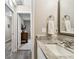 Bathroom boasts granite counters, white cabinets, and access to an adjacent bedroom at 1535 Nursery Rd # 111, Clearwater, FL 33756