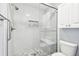Walk-in shower with stone floor and built-in seat in renovated bathroom at 1535 Nursery Rd # 111, Clearwater, FL 33756