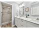 Renovated bathroom showcasing a double vanity, and a modern glass-enclosed shower at 1535 Nursery Rd # 111, Clearwater, FL 33756