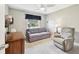 Bedroom features a comfortable seating area and ample natural light from the window at 1535 Nursery Rd # 111, Clearwater, FL 33756