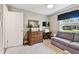 Cozy bedroom with a ceiling fan, a sofa, and a view of the yard from the window at 1535 Nursery Rd # 111, Clearwater, FL 33756