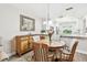Bright dining area with a wooden table and chairs, flowing seamlessly into the kitchen with ample counter space at 1535 Nursery Rd # 111, Clearwater, FL 33756