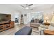Inviting living room with hardwood floors, comfortable sofa, and an open layout connecting to the sunroom and bedroom at 1535 Nursery Rd # 111, Clearwater, FL 33756