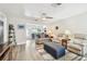 Comfortable living room with neutral-toned furniture, plush seating, and open layout, leading to sunroom through glass doors at 1535 Nursery Rd # 111, Clearwater, FL 33756