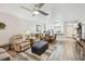 Spacious living area featuring hardwood floors, comfortable seating, and open access to the dining area and kitchen at 1535 Nursery Rd # 111, Clearwater, FL 33756