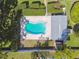 A straight down aerial view shows a well-maintained kidney-shaped pool and patio surrounded by manicured greenery at 1535 Nursery Rd # 111, Clearwater, FL 33756