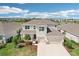Aerial view of a well-maintained two-story home with lush landscaping and a three-car garage at 16709 Barnwood Pl, Bradenton, FL 34211